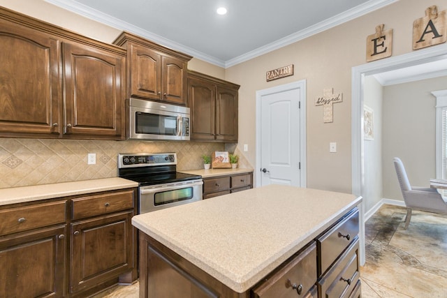 kitchen with tasteful backsplash, ornamental molding, appliances with stainless steel finishes, and a center island