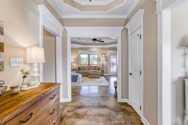 corridor with crown molding and a tray ceiling