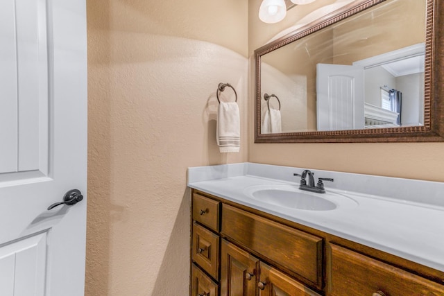 bathroom featuring ornamental molding and vanity