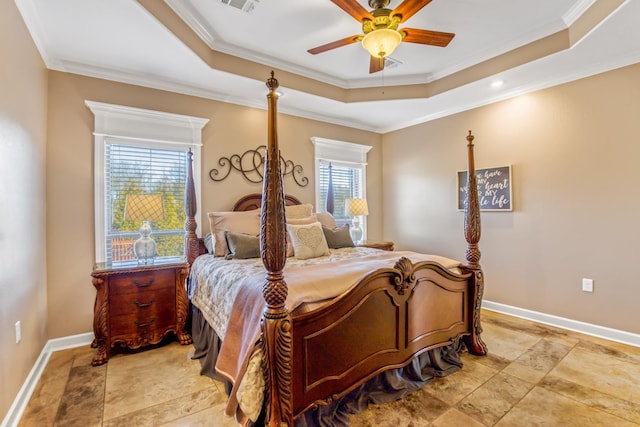 bedroom featuring a tray ceiling, ornamental molding, and ceiling fan