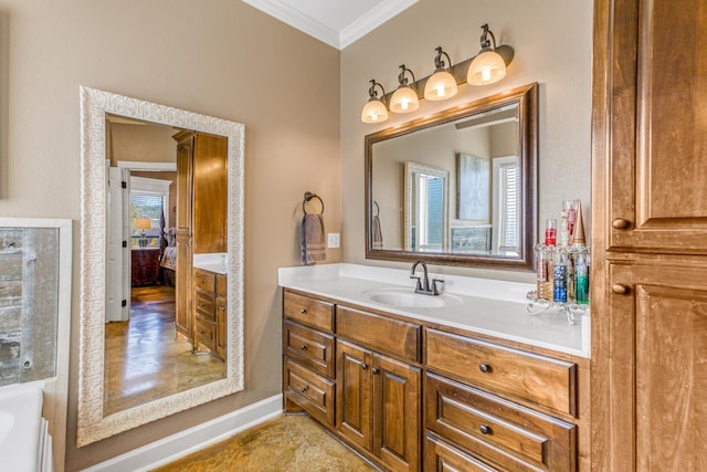 bathroom featuring vanity, a bathtub, plenty of natural light, and ornamental molding