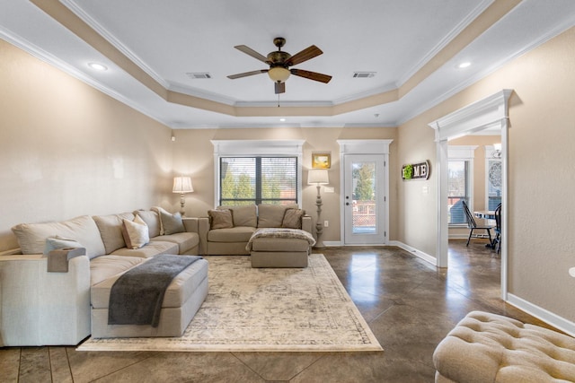 living room featuring ornamental molding, a raised ceiling, and ceiling fan