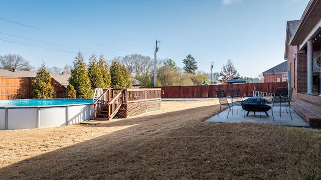 view of yard with a fire pit and a swimming pool side deck