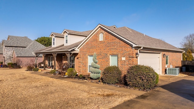 view of front of house with central AC, a garage, and a front yard