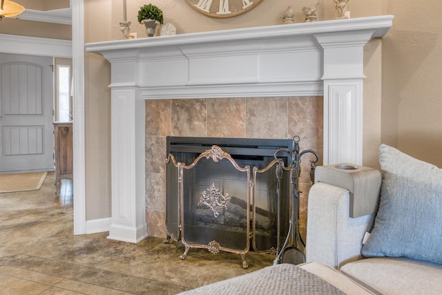 details with ornamental molding and a tile fireplace