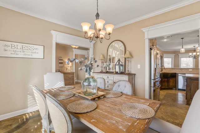 dining space featuring crown molding and an inviting chandelier