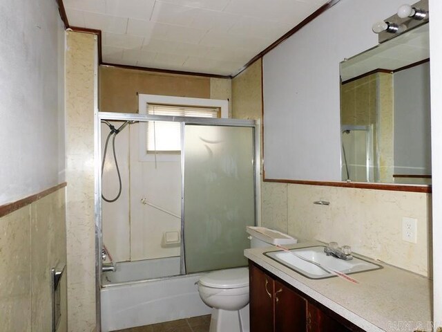 full bathroom with toilet, vanity, and shower / bath combination with glass door