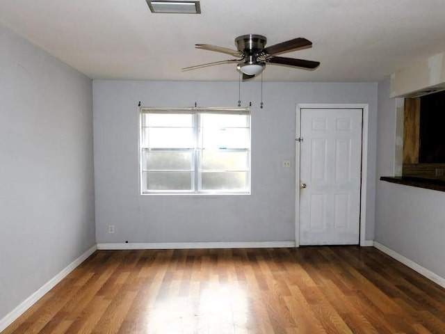 spare room featuring hardwood / wood-style flooring and ceiling fan
