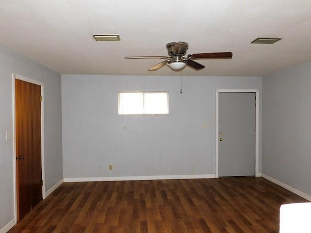 spare room featuring ceiling fan and dark hardwood / wood-style flooring