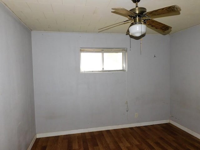 empty room with dark wood-type flooring and ceiling fan