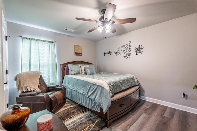 bedroom featuring dark hardwood / wood-style flooring and ceiling fan