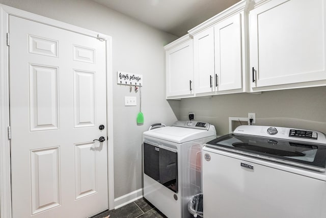 laundry room with cabinets and washing machine and clothes dryer