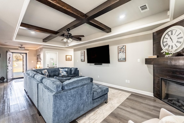 living room featuring coffered ceiling, hardwood / wood-style floors, beamed ceiling, and ceiling fan