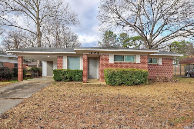 single story home featuring a carport and a front lawn