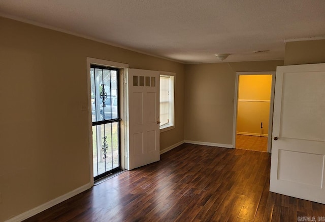 entrance foyer featuring a textured ceiling and dark hardwood / wood-style flooring