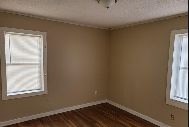 spare room with dark hardwood / wood-style flooring and a textured ceiling