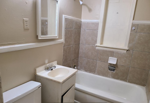 full bathroom featuring vanity, toilet, and tiled shower / bath combo