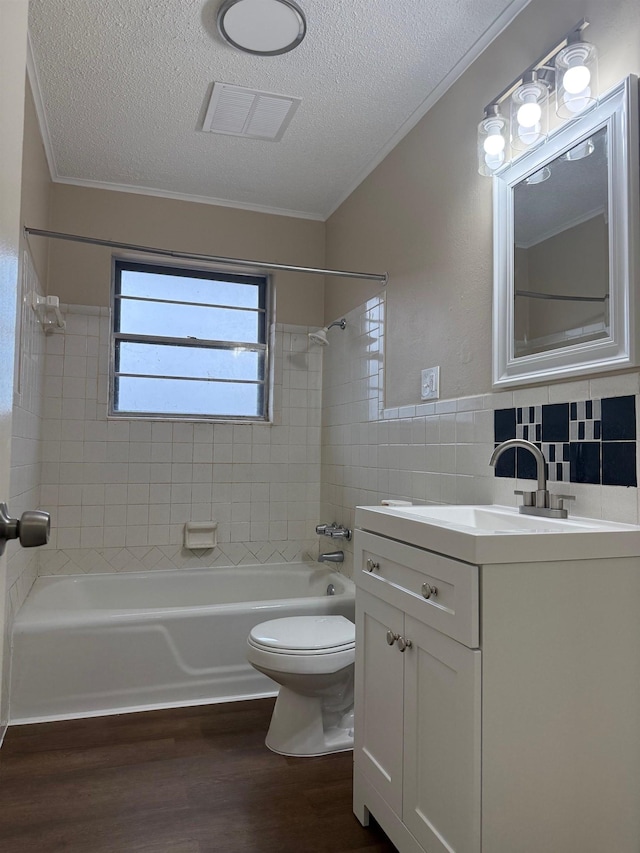 full bathroom featuring toilet, tile walls, a textured ceiling, vanity, and hardwood / wood-style flooring