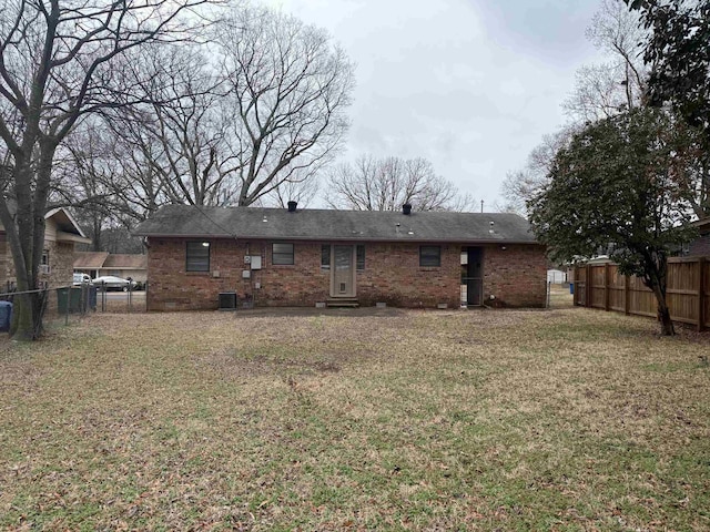 back of property featuring a yard and central air condition unit