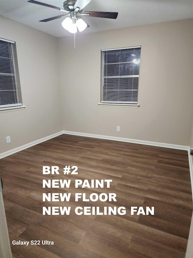 empty room featuring ceiling fan, dark hardwood / wood-style floors, and a textured ceiling