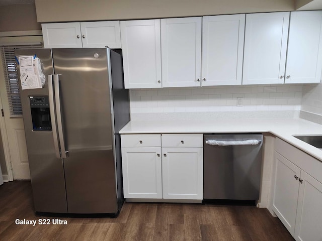 kitchen featuring dark wood-type flooring, stainless steel appliances, and white cabinets