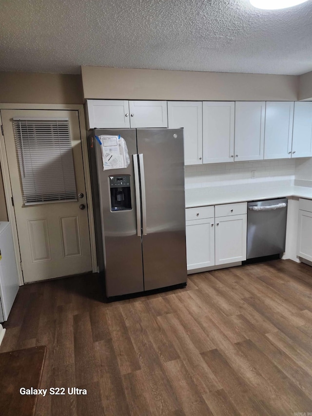 kitchen with hardwood / wood-style flooring, a textured ceiling, white cabinets, and appliances with stainless steel finishes