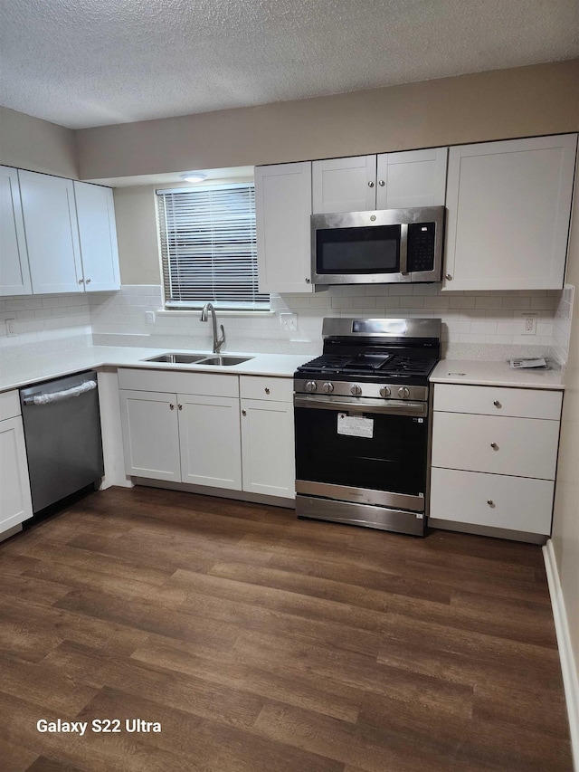 kitchen featuring white cabinetry, appliances with stainless steel finishes, and sink