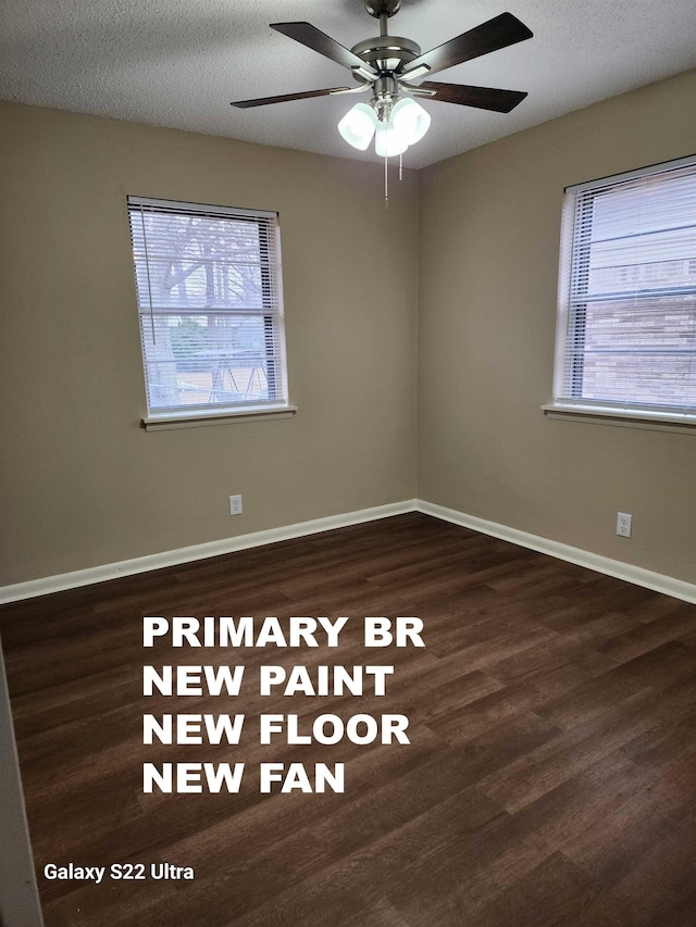 unfurnished room with ceiling fan, a textured ceiling, dark hardwood / wood-style floors, and a healthy amount of sunlight