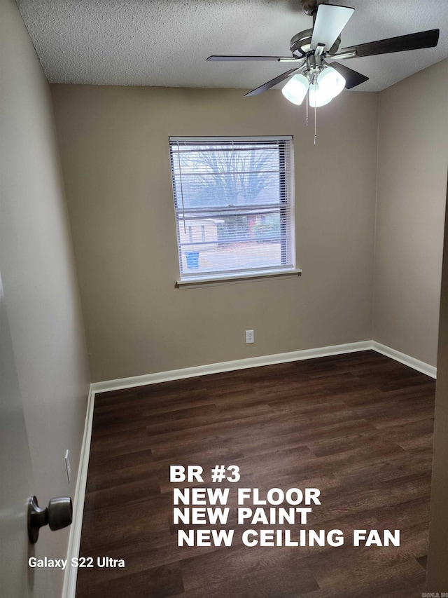 spare room featuring ceiling fan, dark hardwood / wood-style floors, and a textured ceiling