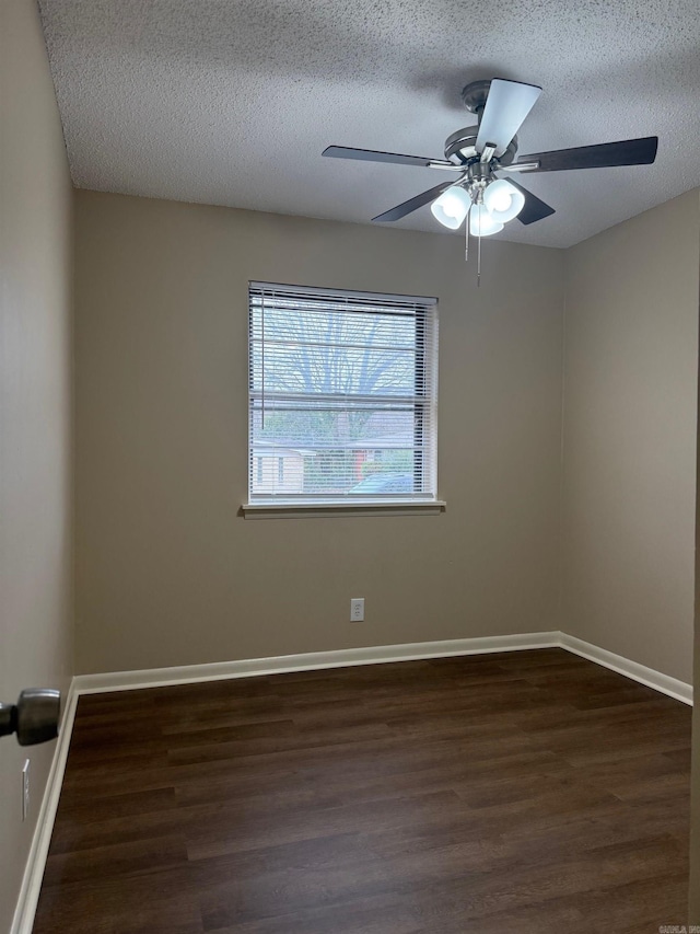 empty room with dark hardwood / wood-style flooring, ceiling fan, and a textured ceiling