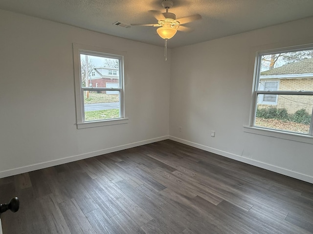 unfurnished room featuring ceiling fan, a textured ceiling, and dark hardwood / wood-style flooring