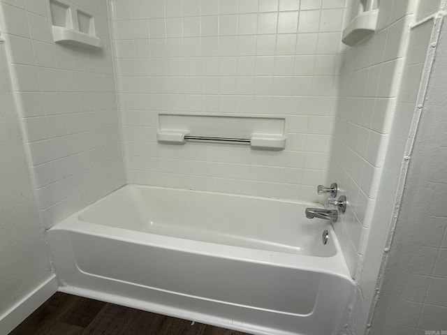 bathroom featuring tiled shower / bath and hardwood / wood-style floors