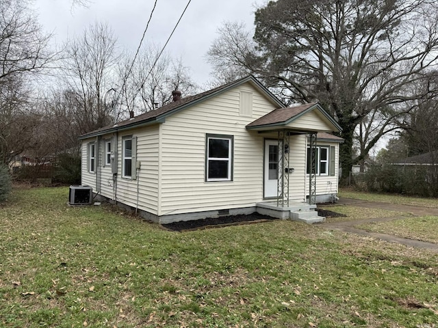 view of front facade with central AC unit and a front lawn