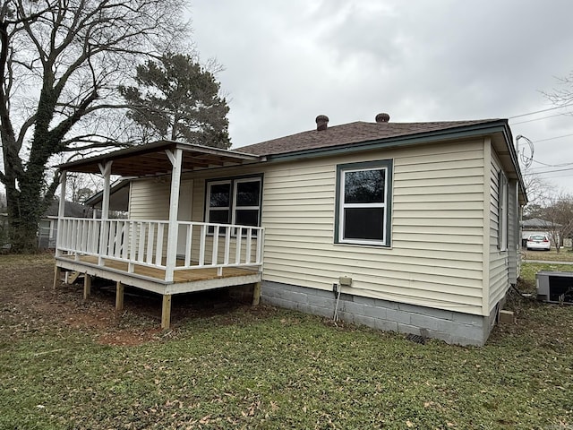 back of property with central AC unit, a yard, and a deck