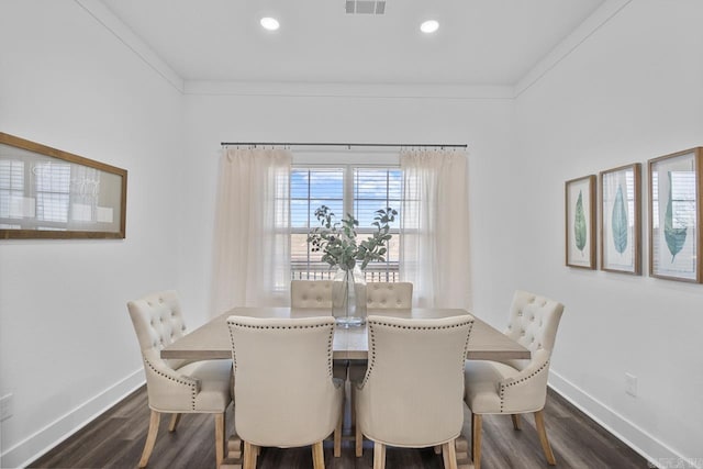 dining area featuring ornamental molding and dark hardwood / wood-style floors