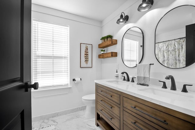 bathroom featuring vanity and toilet