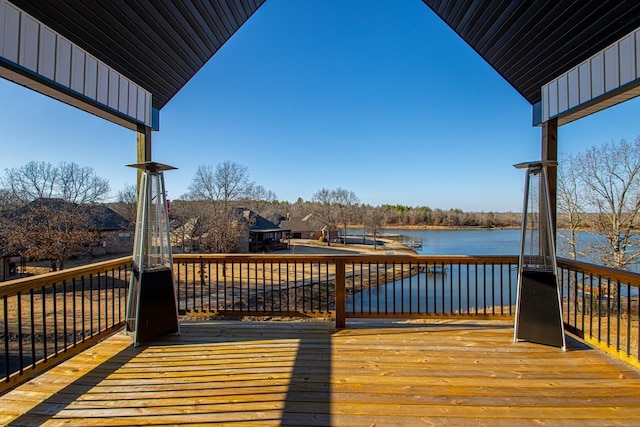 wooden terrace featuring a water view