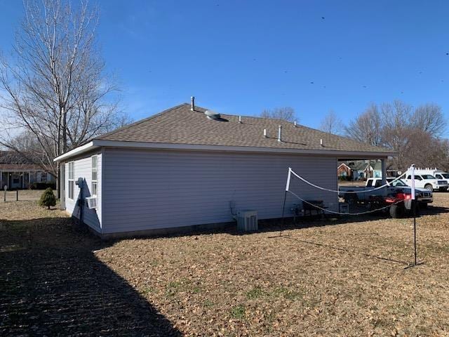 view of property exterior featuring a lawn and central air condition unit