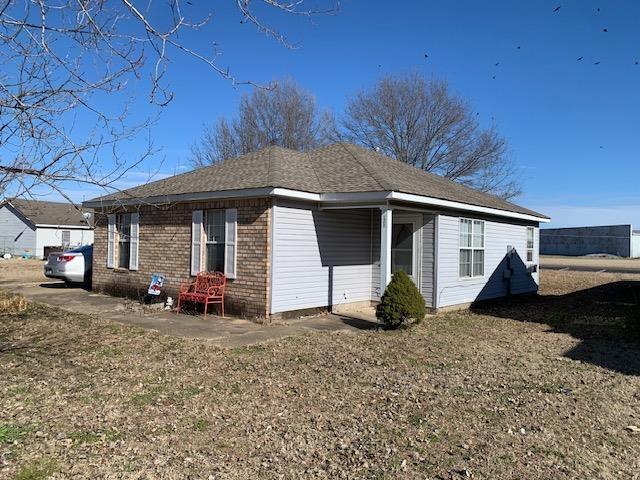 view of property exterior with a yard