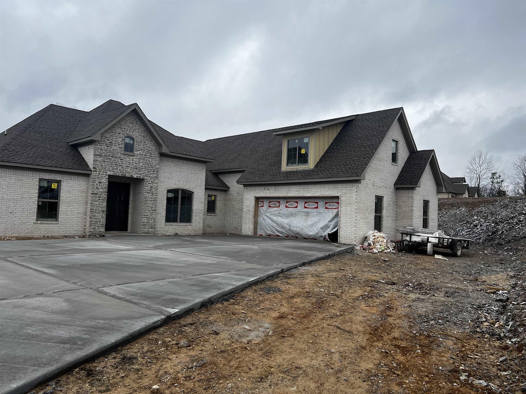 french country style house featuring a garage