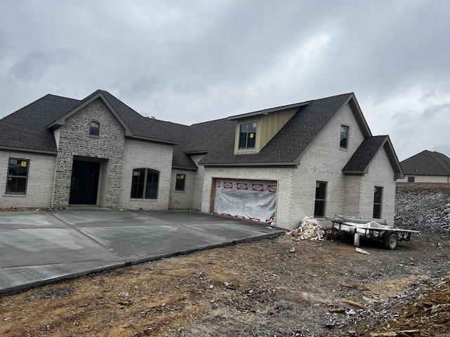 french provincial home featuring a garage