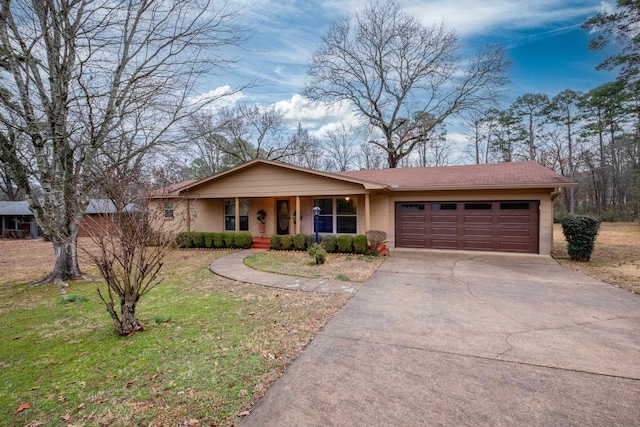 single story home with a porch, a garage, and a front lawn