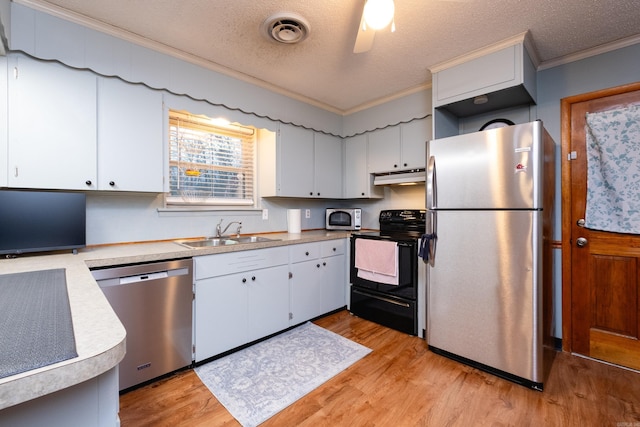 kitchen featuring sink, crown molding, light hardwood / wood-style flooring, appliances with stainless steel finishes, and white cabinets