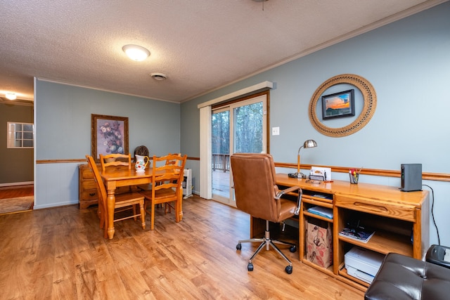 interior space featuring crown molding, hardwood / wood-style floors, and a textured ceiling