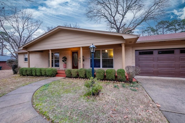 single story home featuring a garage and covered porch