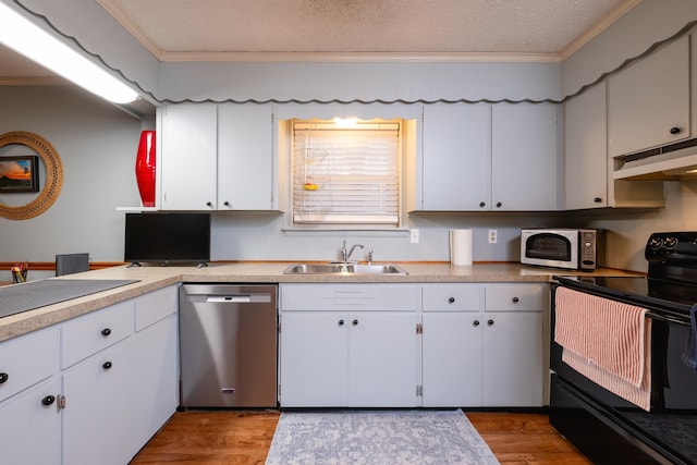 kitchen with white cabinetry, appliances with stainless steel finishes, crown molding, and sink