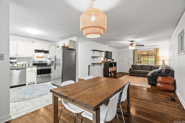 dining space featuring hardwood / wood-style flooring and ceiling fan