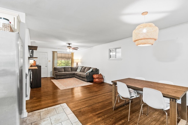 dining area featuring dark wood-type flooring and ceiling fan