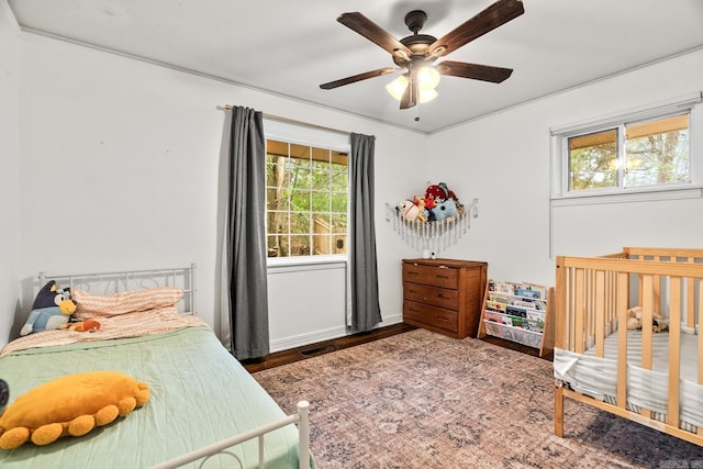 bedroom with hardwood / wood-style floors and ceiling fan