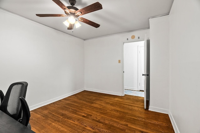 unfurnished office with ceiling fan and dark hardwood / wood-style flooring